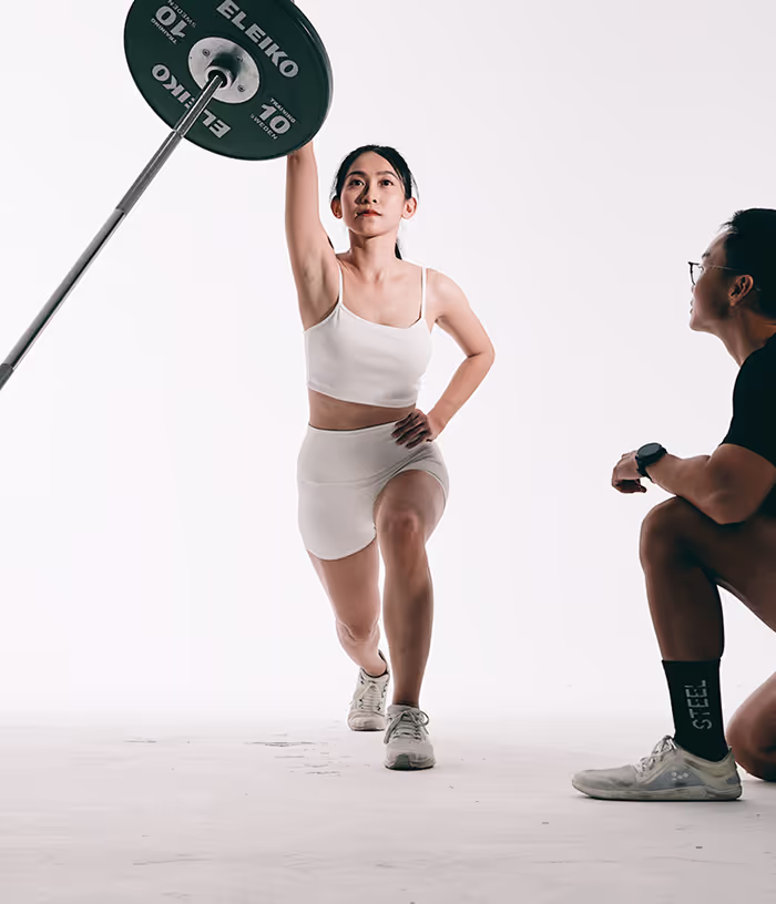 STEEL Saigon personalised training - elite coach guiding client with Eleiko for custom fitness goals